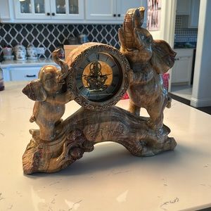 Antique elephant clock with Chinese lettering in the front